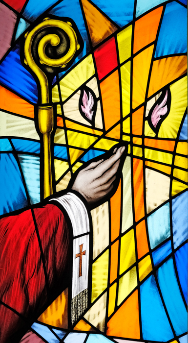 Artist's Stained Glass window with the bishop's arm extended towards flames