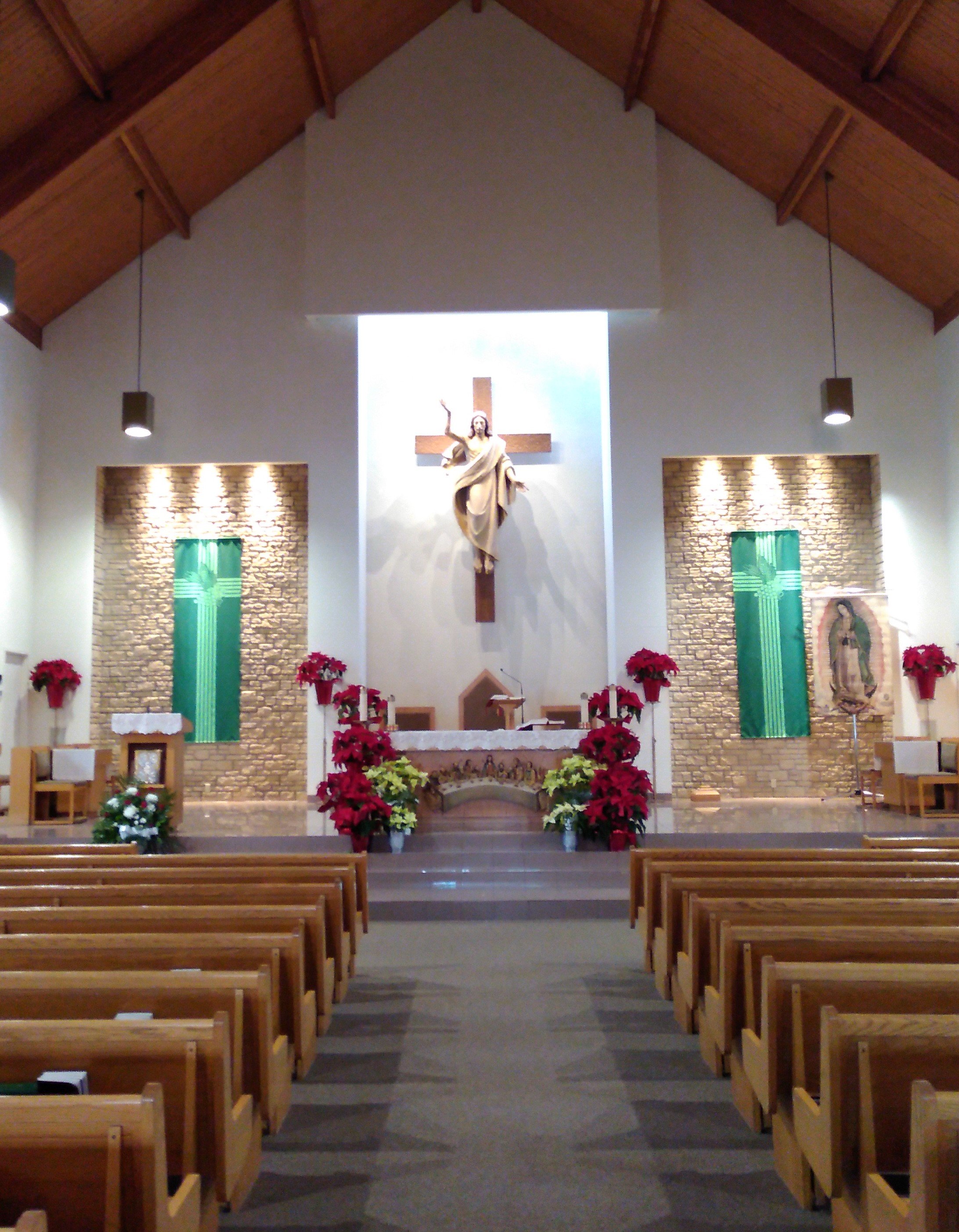 St. Leonard's church looking toward the altar at the Risen Christ and green banners on each side